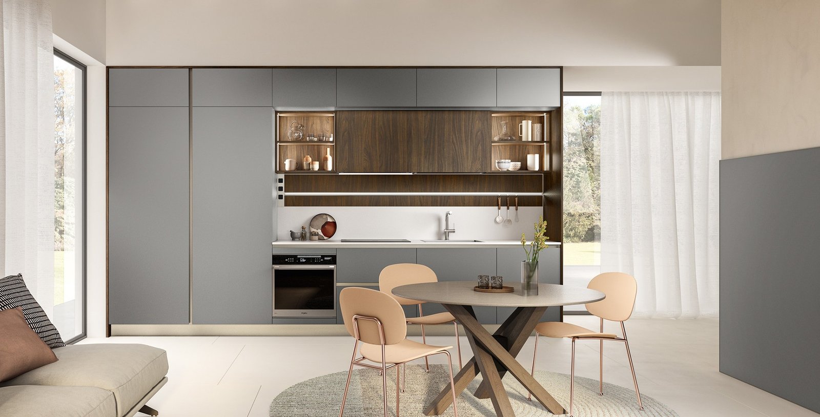 Veneta Cucine style modern Italian kitchen with matte gray cabinetry, warm wood accents, integrated storage, and a round dining table in a bright open living space.