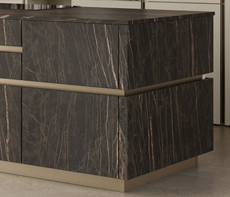 Close-up of a modern Italian kitchen island with dark ceramic stone-look cabinet panels, slim metallic detailing, and a refined contemporary finish.