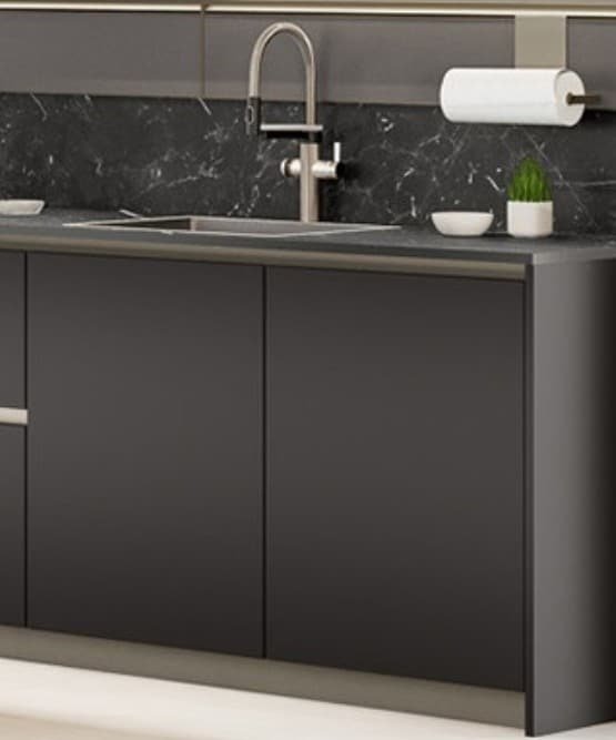Modern Italian kitchen cabinets in a dark matte colorboard melamine finish with integrated sink, sleek faucet, and black stone backsplash.
