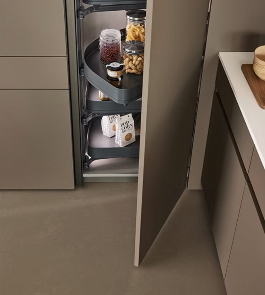 Modern kitchen pantry cabinet with Fenix-style matte finish, open pull-out corner storage shelves, and concealed functional organization.