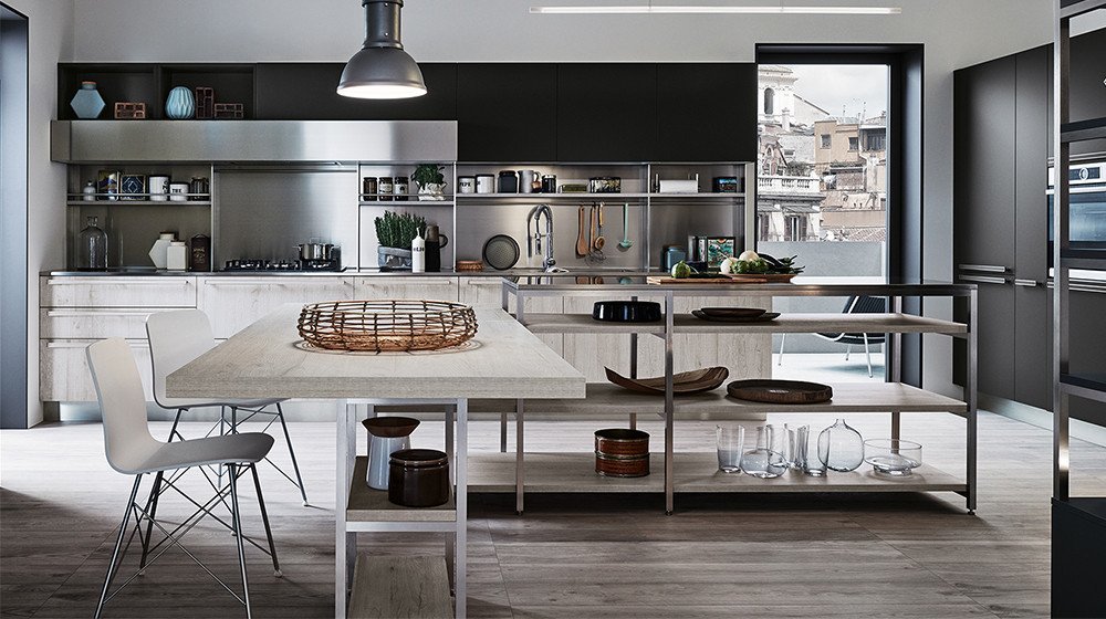 Discover the Ethica collection by Veneta Cucine at Studio Quattro Design. This urban, industrial-inspired kitchen blends matte black cabinetry, textured bleached wood surfaces, and sleek stainless steel open shelving structures.