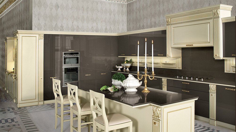 Discover the Mirabeau collection by Veneta Cucine at Studio Quattro Design. This opulent neo-classical kitchen brings timeless luxury forward with high-gloss dark brown lacquer cabinetry, intricate cream architectural framing, and exquisite gold leaf accents.