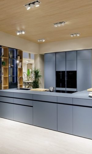 Contemporary kitchen with Italian cabinetry, wood ceiling detail, and integrated storage solutions in a modern home