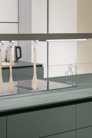 Modern kitchen island with Italian cabinetry, integrated cooktop, and minimalist surface design