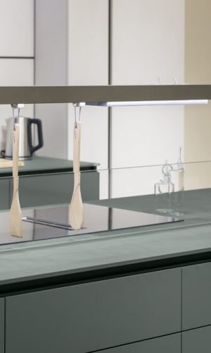 Modern kitchen island with Italian cabinetry, integrated cooktop, and minimalist surface design