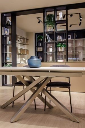 Modern dining room with custom table, designer seating, and luxury built-in shelving with contemporary European cabinetry.