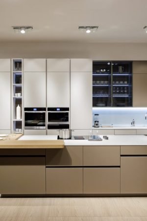 Flat panel kitchen cabinets in a luxury open concept interior featuring modern kitchen cabinet design, wood finishes, sleek lines, and contemporary elegance.