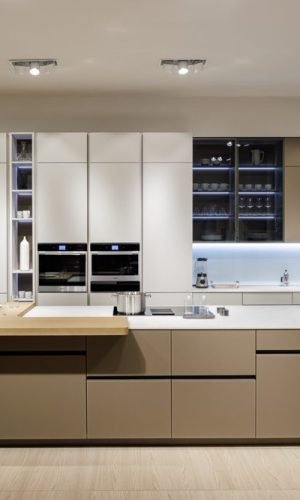 Flat panel kitchen cabinets in a luxury open concept interior featuring modern kitchen cabinet design, wood finishes, sleek lines, and contemporary elegance.