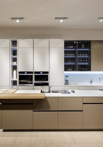 Flat panel kitchen cabinets in a luxury open concept interior featuring modern kitchen cabinet design, wood finishes, sleek lines, and contemporary elegance.