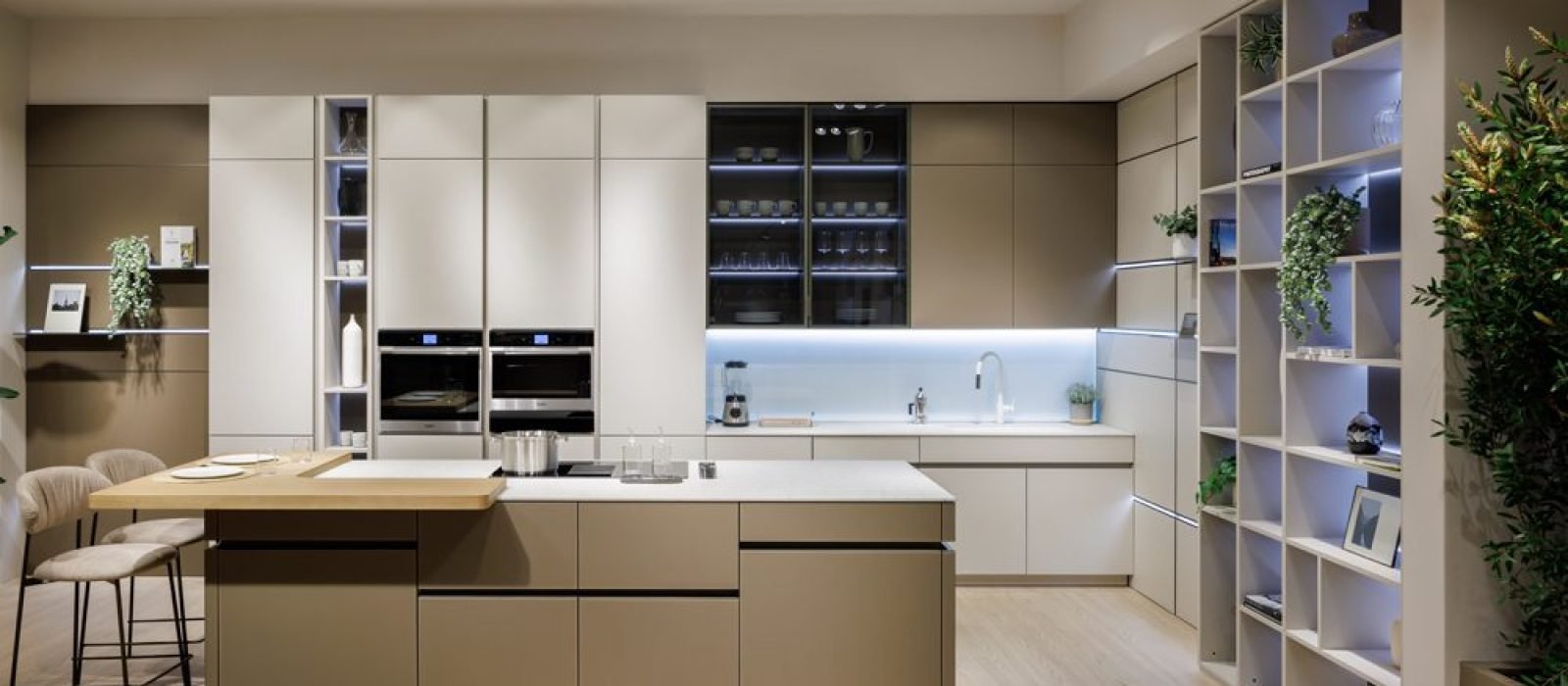 Kitchen showrooms near me featuring modern custom cabinetry, illuminated shelving, integrated appliances, kitchen island, and luxury European design.