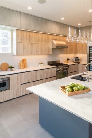 Modern kitchen cabinet design with long island, natural wood cabinets, integrated appliances, and sleek contemporary finishes.