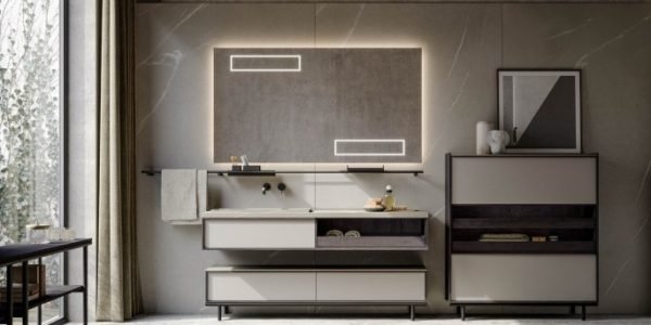 Modern Italian bathroom with sleek vanity, backlit rectangular mirror, floating storage drawers, tall cabinet, stone wall panels, and soft natural light.