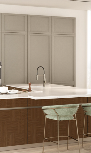 Classic neutral kitchen with paneled upper cabinetry, natural wood island cabinets, integrated appliances, white countertop, and elegant bar seating.